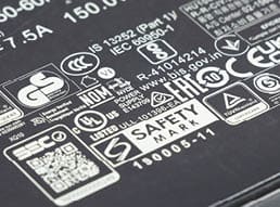 Aktau, Kazakhstan - March 25, 2025: Close-up of laptop charger label with safety markings and specifications.